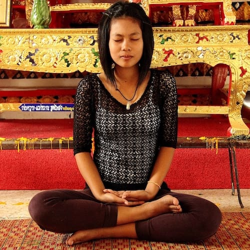 Stress and Anger Hypnotherapy for Stress and Anger - A lady stress-free sitting crosslegged in a yoga pose